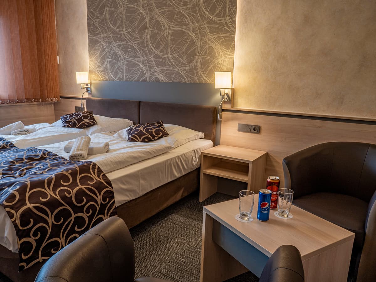 Bed with decorative pillows and modern lighting