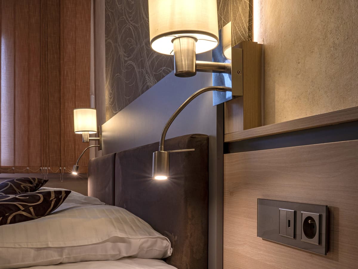 Close-up of lamp and switch next to bed