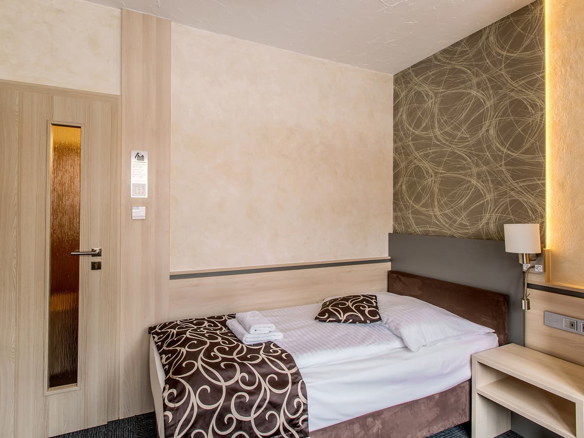 Single room with elegant wallpaper and wooden paneling