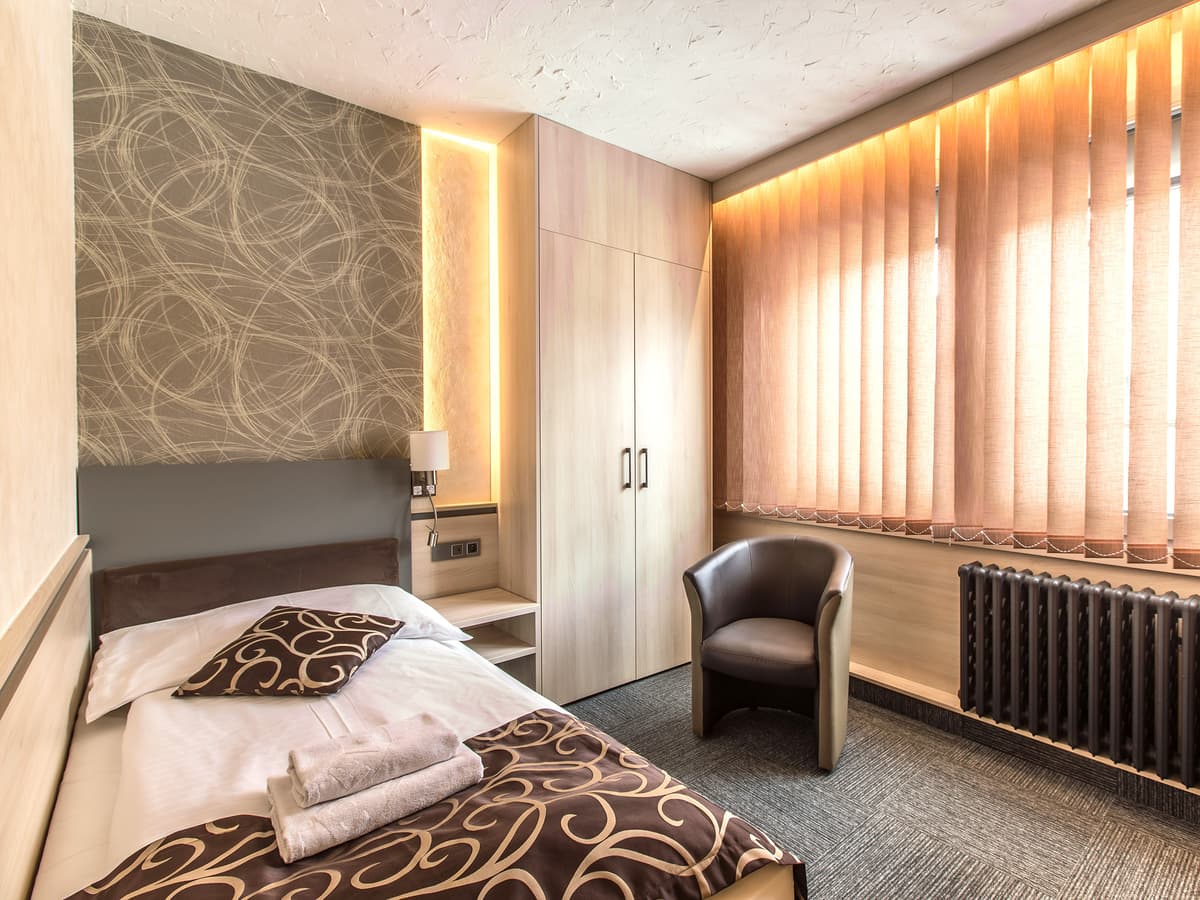 Room with large windows and two beds