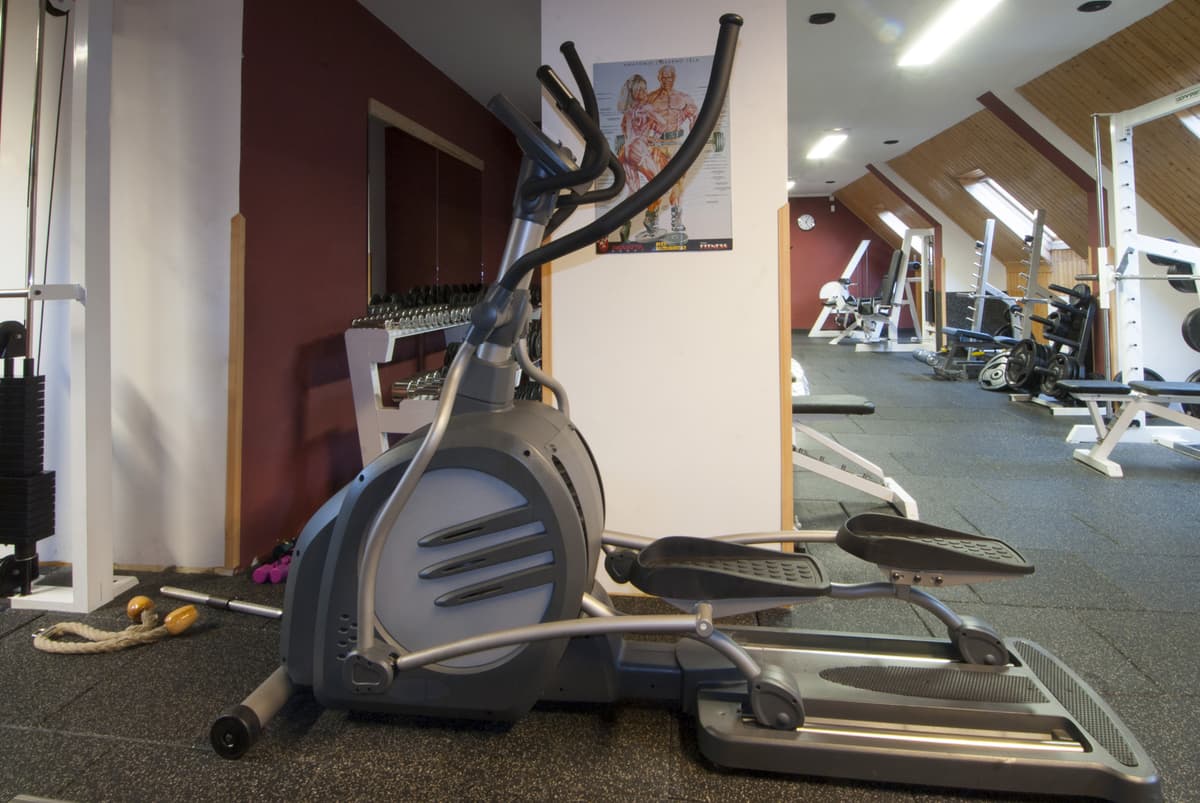 An elliptical trainer in the gym, which is intended for cardio exercise.