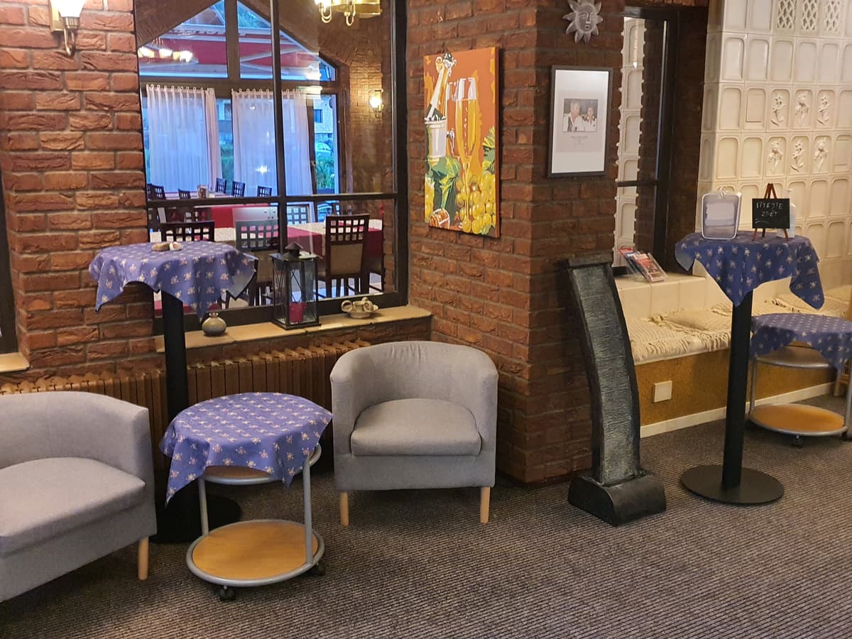 Café interior with round tables and armchairs