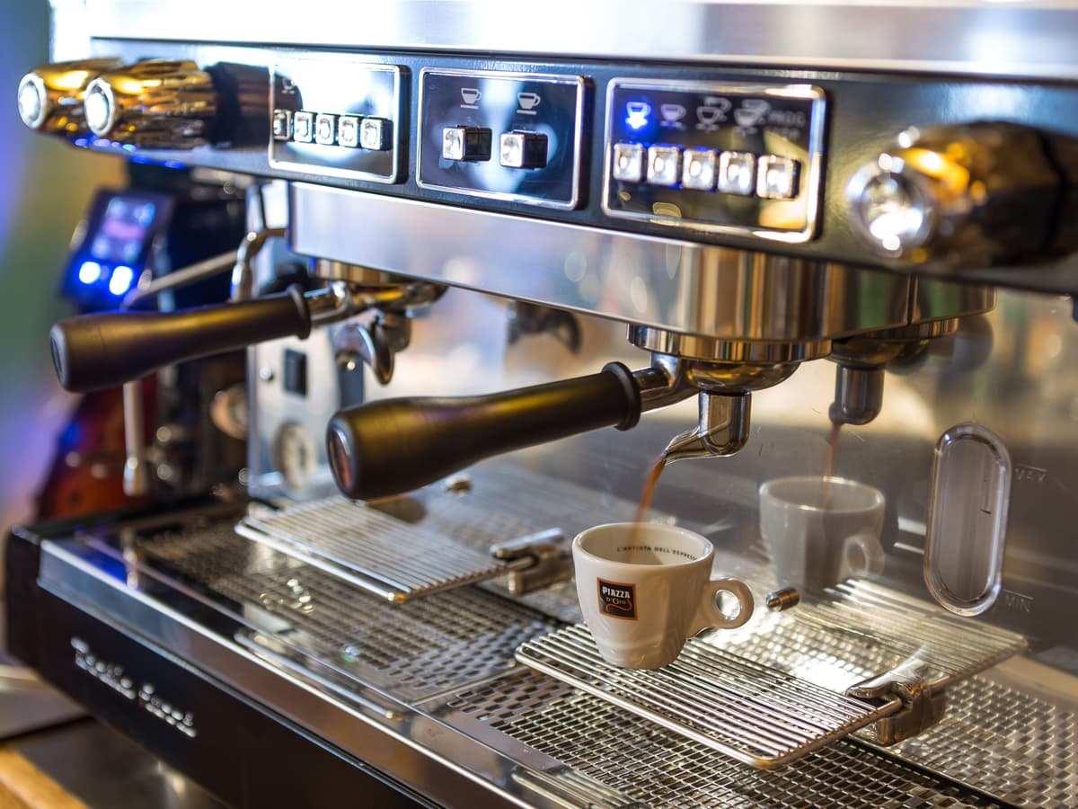 Detail of coffee preparation on a professional coffee machine.