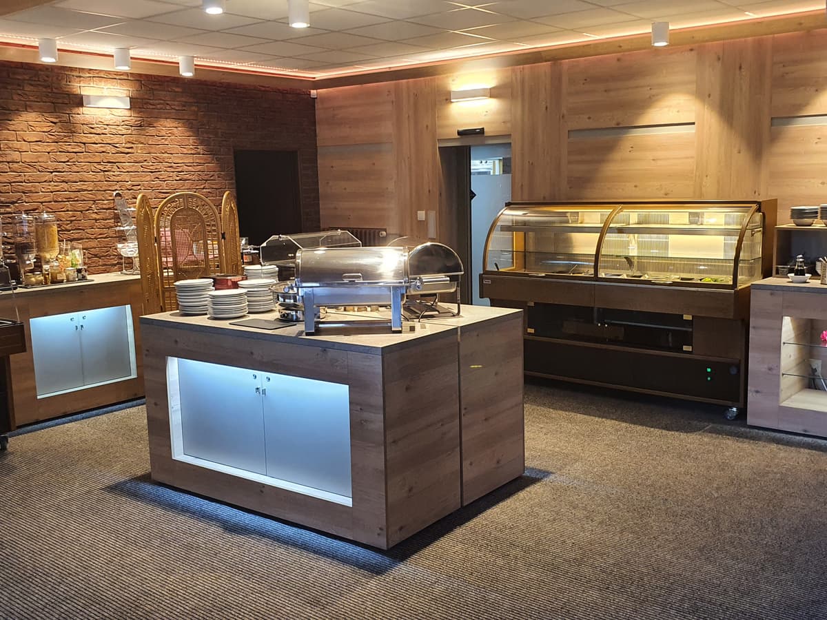 Buffet with refrigerated display cases with various cold and hot dishes.
