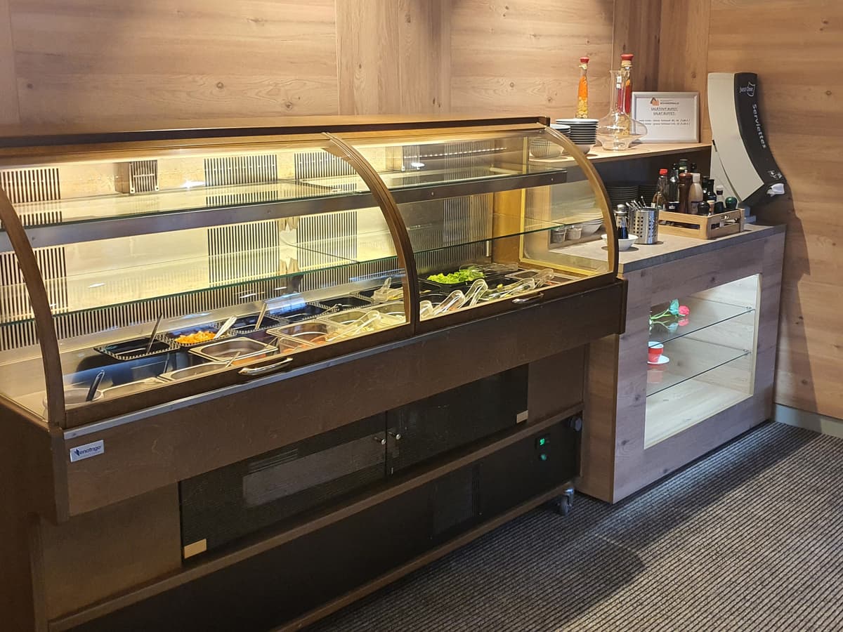 Glass display case with a selection of desserts and cakes.