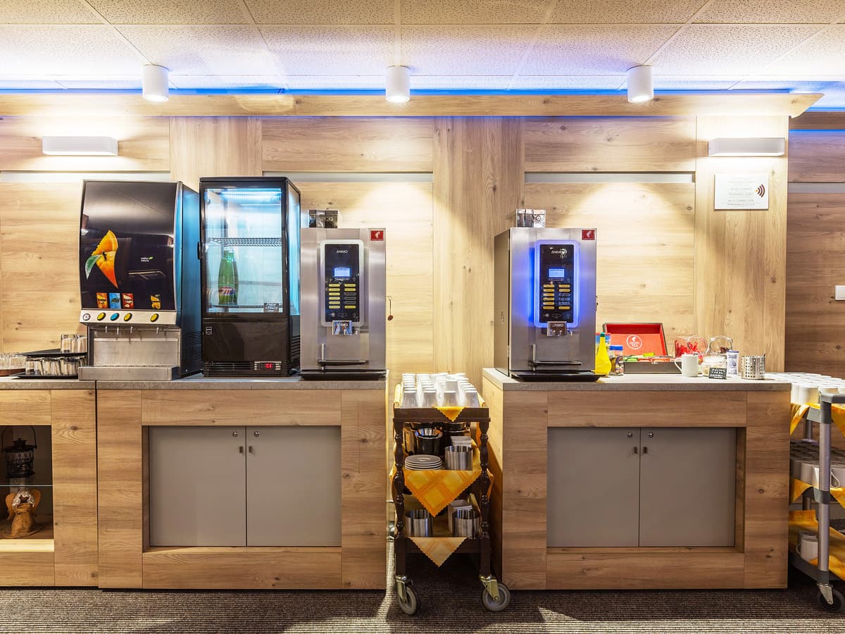 Self-service counter with modern coffee machines.